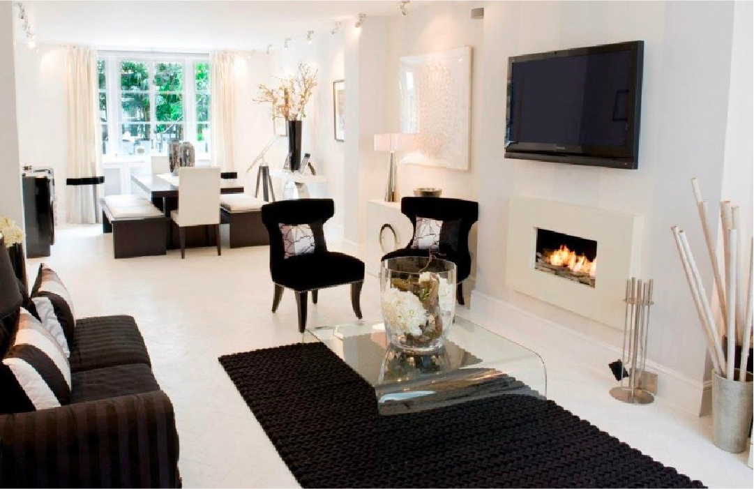 Ribbon flame with limestone surround in elegant living room.