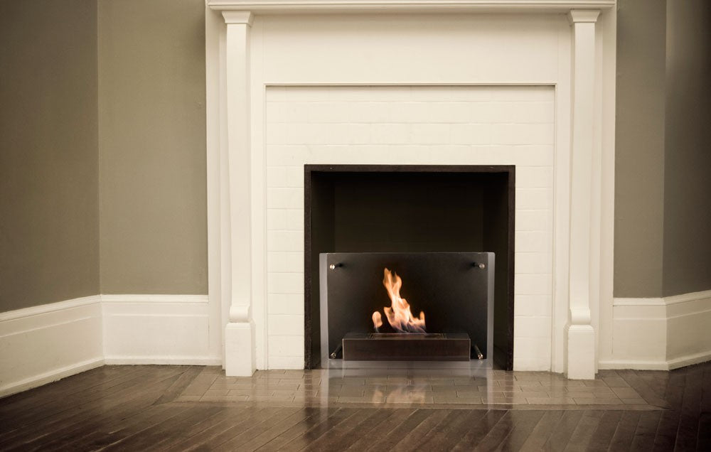 CAPRI Bioethanol Fire in fireplace opening with white mantlepiece