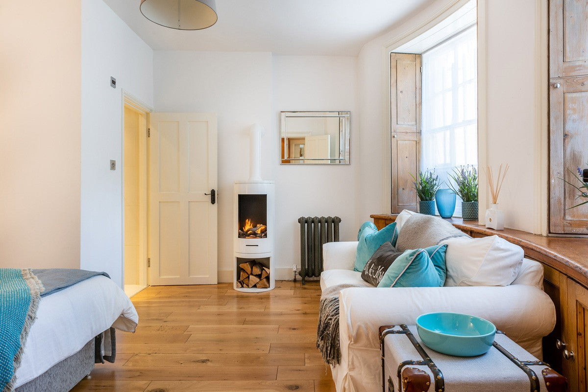 White Large Pipe on White Cylinder stove in bedroom