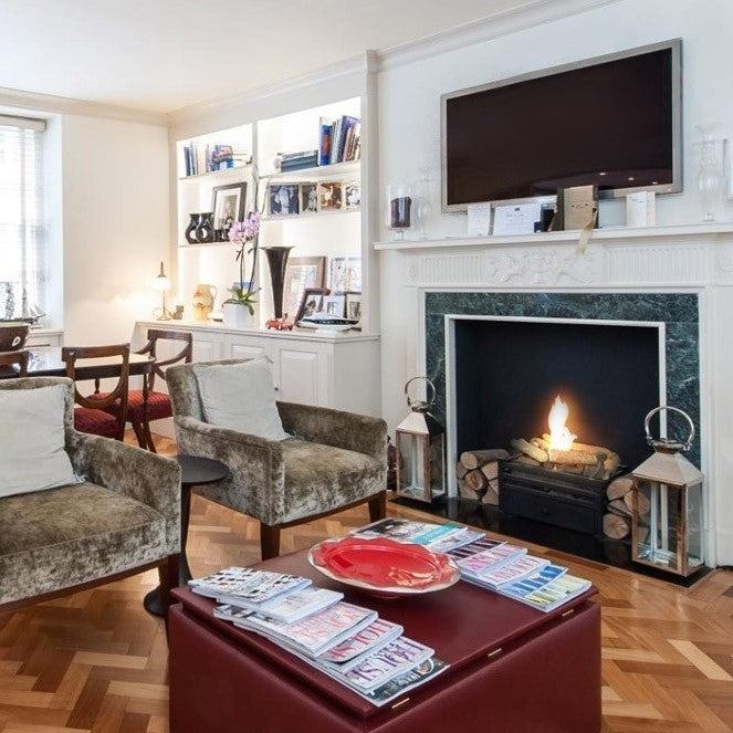 CHELSEA Black Bioethanol Grate in fireplace with green marble  mantelpiece in waiting room