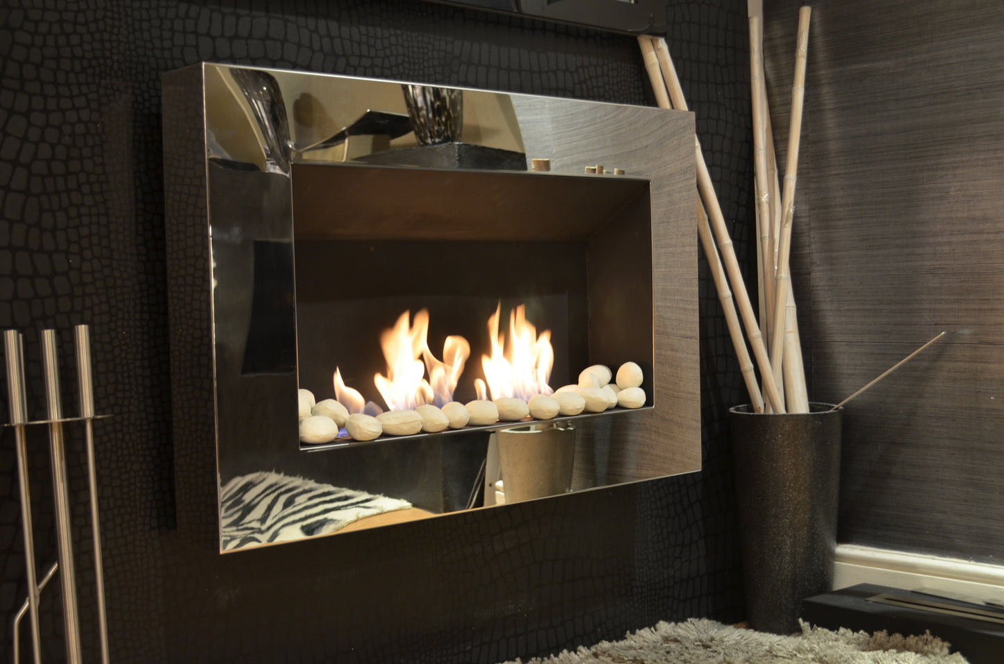 Phantom mirrored fireplace with white pebbles.