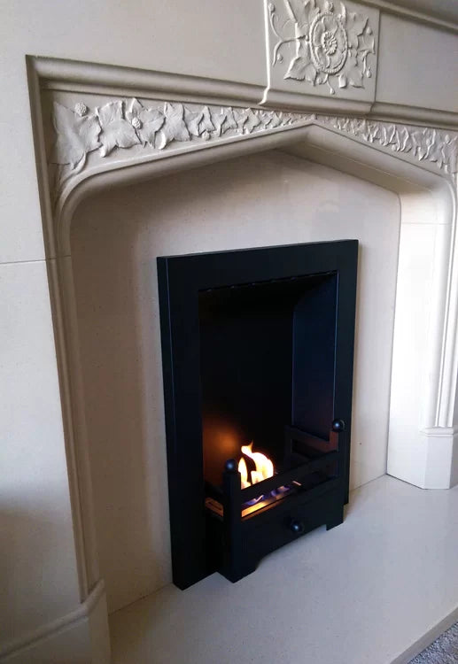 Miniburner in old white stone fireplace