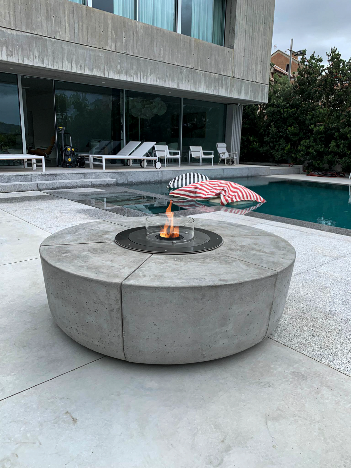 Round Automatic Insert with brushed stainless steel top plate installed in Zarzuela cement firepit