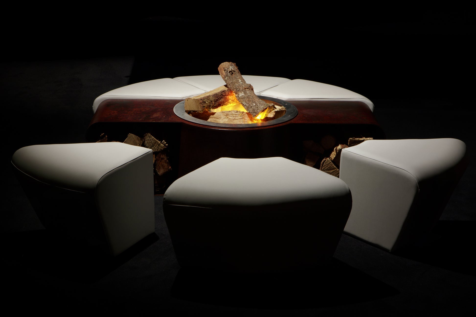 Circus with wood burner, rusted corten steel body and white ottomans. Display picture.