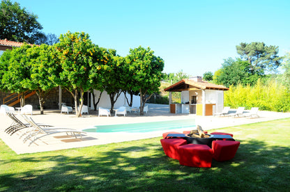 Circus with wood burner and red ottomans. Picture in country side hotel garden with swimming pool