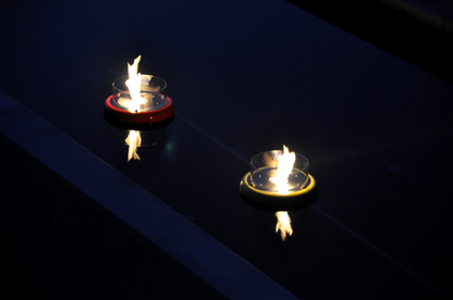 Flut Red  and Yellow fireplaces set up in outdoor suspended swimming pool. Close up picture on fireplaces and flame reflecting effect.