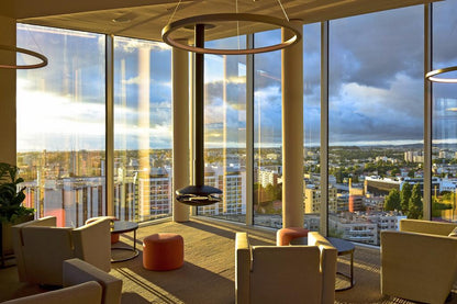 PEROLA Black Contemporary Bioethanol Stove on elegant hotel lounge with wide windows.
